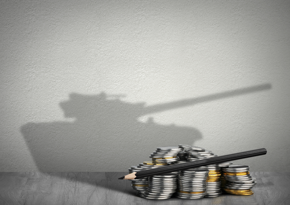 Military logistics officers reviewing a blockchain-enabled procurement dashboard